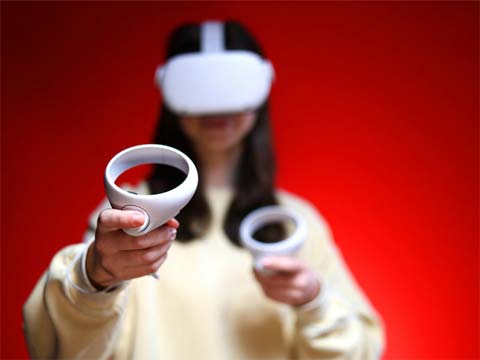 Schülerin mit VR-Brille und VR-Controller.